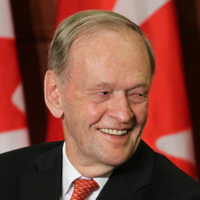 http://alt=%20The%2020th%20prime%20minister%20of%20Canada,%20Jean%20Chrétien,%20smiling%20with%20Canadian%20flags%20behind%20him.