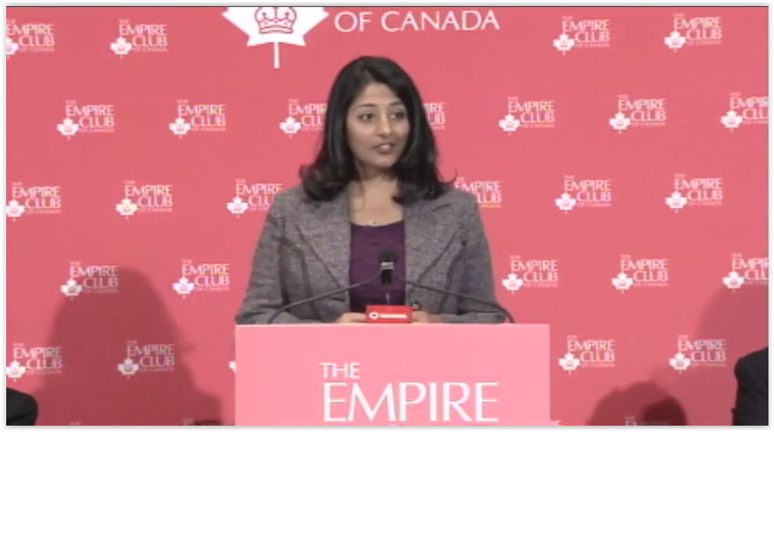 a female speaker delivering a keynote speech at the Empire Club of Canada's poidum